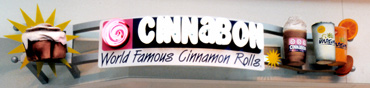 storefront signage with drinks and cinnamin rolls