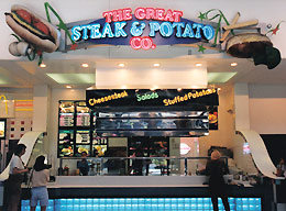 restaurant storefront with steak, potato and french fries