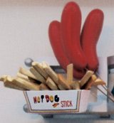 sculptures of hotdogs on sticks and french fries