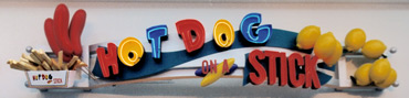 storefront signage with hot dog, french fries and lemon sculptures